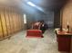 Interior of a one car garage with wood paneling with work bench and tractor with front loader at 3220 Indian Shoals Rd, Dacula, GA 30019