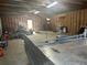 Spacious interior of a large garage with tractor, wheelbarrow, and utility trailer for secure storage at 3220 Indian Shoals Rd, Dacula, GA 30019
