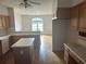 Spacious kitchen showcasing wood floors, cabinets, and a view into an open dining area at 3220 Indian Shoals Rd, Dacula, GA 30019