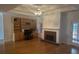 Cozy living room with a brick fireplace, built-in bookshelves, and hardwood floors at 3220 Indian Shoals Rd, Dacula, GA 30019
