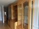 Elegant living room with custom cabinets, glass display cases, and hardwood floors at 3220 Indian Shoals Rd, Dacula, GA 30019