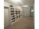 Large room with an extensive built-in bookcase and multiple shelves offers ample storage and display space at 3220 Indian Shoals Rd, Dacula, GA 30019
