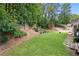 A lush green backyard with trees and shrubbery, providing a serene outdoor space at 3460 Trow Creek Ln, Cumming, GA 30040