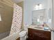 Full bathroom with a shower, bathtub, and stylish polka dot curtain at 3460 Trow Creek Ln, Cumming, GA 30040