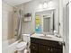 Traditional bathroom featuring shower/tub, tile walls, and single sink vanity at 3460 Trow Creek Ln, Cumming, GA 30040