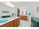 Bright bathroom with dual vanities, wood cabinets, and tile flooring at 3460 Trow Creek Ln, Cumming, GA 30040