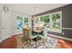 Well-lit dining room featuring hardwood floors, a modern chandelier, and backyard view at 3460 Trow Creek Ln, Cumming, GA 30040