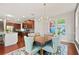 Open dining room with hardwood floors, chandelier, backyard views, and adjoined kitchen area at 3460 Trow Creek Ln, Cumming, GA 30040