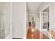 Inviting foyer with hardwood floors, decorative front door, and view into office and dining room at 3460 Trow Creek Ln, Cumming, GA 30040