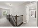 Upstairs hallway with dark wood railing and carpet at 3460 Trow Creek Ln, Cumming, GA 30040