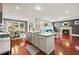 Open-concept kitchen with stainless steel appliances, an island, and dining area at 3460 Trow Creek Ln, Cumming, GA 30040
