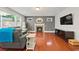 Inviting living room featuring hardwood floors, a cozy fireplace, and lots of natural light at 3460 Trow Creek Ln, Cumming, GA 30040