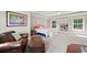 Spacious main bedroom with seating area, tray ceiling, and lots of natural light at 3460 Trow Creek Ln, Cumming, GA 30040