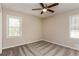 Bright bedroom features a ceiling fan and plush gray carpeting throughout at 114 Howell Sw Dr, Atlanta, GA 30331