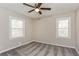 This bright bedroom features neutral walls, plush carpeting and a ceiling fan at 114 Howell Sw Dr, Atlanta, GA 30331