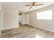 Bright living room featuring sleek gray flooring, neutral walls, and a ceiling fan at 114 Howell Sw Dr, Atlanta, GA 30331