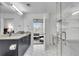 Bright bathroom featuring dual sinks, granite countertops, and a glass walk-in shower at 860 Peachtree Ne St # 1502, Atlanta, GA 30308