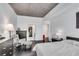 Modern bedroom with dark hardwood floors, gray accent chair, and a view of a walk-in closet at 860 Peachtree Ne St # 1502, Atlanta, GA 30308