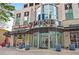 Commercial building entrance with glass doors, retail shops, and outdoor seating area at 860 Peachtree Ne St # 1502, Atlanta, GA 30308