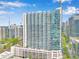 View of high-rise condominium building with large windows, multiple balconies, and parking garage at 860 Peachtree Ne St # 1502, Atlanta, GA 30308
