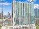 A high rise condominium building featuring many stories, glass windows, and multiple balconies at 860 Peachtree Ne St # 1502, Atlanta, GA 30308
