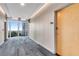 Apartment hallway with view, featuring carpet flooring, neutral walls, and a doorway at 860 Peachtree Ne St # 1502, Atlanta, GA 30308
