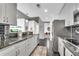 Modern kitchen boasts stainless steel appliances, granite countertops, and sleek white cabinetry at 860 Peachtree Ne St # 1502, Atlanta, GA 30308