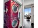 Modern laundry room features a stacked red washer and dryer in a closet space at 860 Peachtree Ne St # 1502, Atlanta, GA 30308