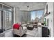 Bright living room boasts expansive windows with city views and sleek, modern finishes at 860 Peachtree Ne St # 1502, Atlanta, GA 30308