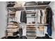 A well-organized walk-in closet features shelving for clothes and accessories at 860 Peachtree Ne St # 1502, Atlanta, GA 30308
