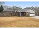 View of home's backyard featuring a wooden fence, garage and covered patio at 6069 Shallow Wood Ln, Douglasville, GA 30135