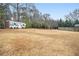 Expansive backyard with grass, trees, landscaping, and a shed at 6069 Shallow Wood Ln, Douglasville, GA 30135