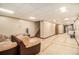Finished basement featuring ceramic tile, recessed lighting, and large sectional at 6069 Shallow Wood Ln, Douglasville, GA 30135