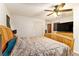 Well-lit bedroom featuring a queen-size bed, ceiling fan, and a closet at 6069 Shallow Wood Ln, Douglasville, GA 30135