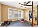 View of the workout area with ample natural light, exercise equipment, and rubber flooring at 6069 Shallow Wood Ln, Douglasville, GA 30135