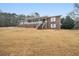 Charming brick home features a covered front porch and mature trees on a spacious lawn at 6069 Shallow Wood Ln, Douglasville, GA 30135