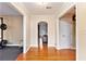 Bright foyer with hardwood floors, arched doorway, and access to multiple rooms at 6069 Shallow Wood Ln, Douglasville, GA 30135