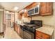Traditional kitchen featuring wooden cabinetry, granite countertops, and stainless steel appliances at 6069 Shallow Wood Ln, Douglasville, GA 30135