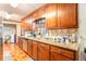 Traditional kitchen featuring warm wood cabinetry, granite countertops, tile backsplash, and stainless steel appliances at 6069 Shallow Wood Ln, Douglasville, GA 30135