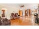 Spacious living room with hardwood floors, natural light, and comfortable seating at 6069 Shallow Wood Ln, Douglasville, GA 30135