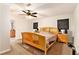 Bedroom with a light wood frame bed, neutral carpeting, and plenty of natural light at 6069 Shallow Wood Ln, Douglasville, GA 30135