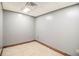 Neutral room featuring tile floors, grey painted walls, and fluorescent lighting at 6069 Shallow Wood Ln, Douglasville, GA 30135