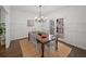 Spacious dining room with a large table, wainscoting, and a modern chandelier at 1080 Bailiff Ne Ct, Brookhaven, GA 30319