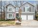 Charming two-story home with gray siding, white trim, and a well-manicured front lawn at 1080 Bailiff Ne Ct, Brookhaven, GA 30319