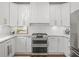 Bright kitchen featuring white cabinetry, stainless steel appliances, and a double oven at 1080 Bailiff Ne Ct, Brookhaven, GA 30319