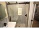 Bathroom features a modern sink, tiled shower with glass doors, and pebble floor at 127 Marona Ne St, Atlanta, GA 30307