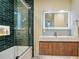 Bathroom featuring new tiled shower with glass door and modern sink with vanity at 127 Marona Ne St, Atlanta, GA 30307