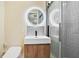 This bathroom features a modern vanity, lighted mirror, and tiled shower with glass doors at 127 Marona Ne St, Atlanta, GA 30307