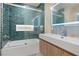 Bathroom featuring new tiled shower with glass door and modern sink with vanity at 127 Marona Ne St, Atlanta, GA 30307