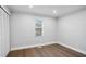 This bedroom features wood flooring, a window and a closet with bi-fold doors at 127 Marona Ne St, Atlanta, GA 30307